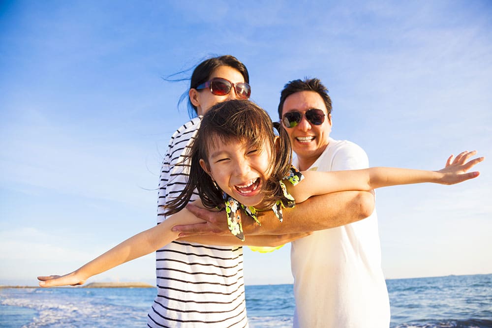 happy family Image of a happy family depicting family protection insurance By Oceanfront Wealth Inc in Vancouver BC